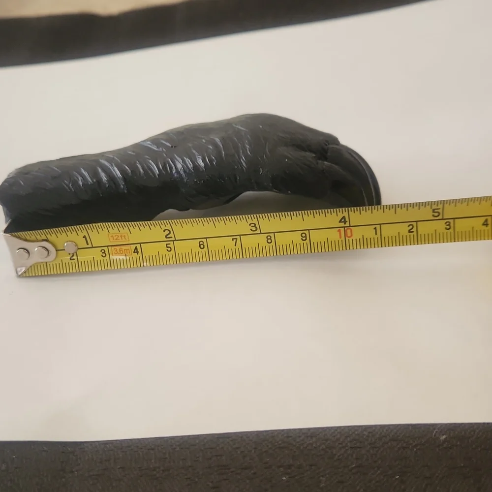 RESIN AND METAL BEAR PAW BOTTLE OPENER.